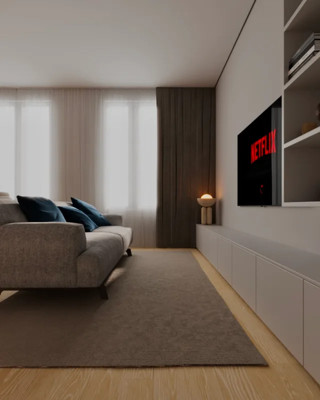 Render de sala de estar com sofá cinza, almofadas azuis e televisão em painel branco.
